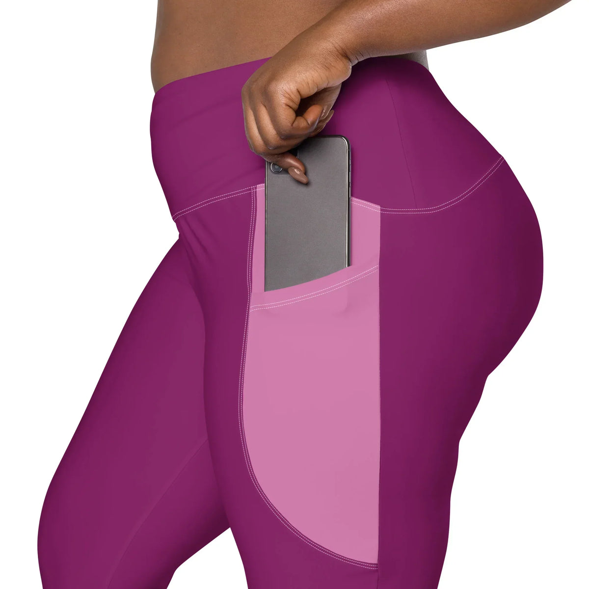 Nahaufnahme der CREWILD Leggings in Pink mit einer praktischen Seitentasche für ein Smartphone.