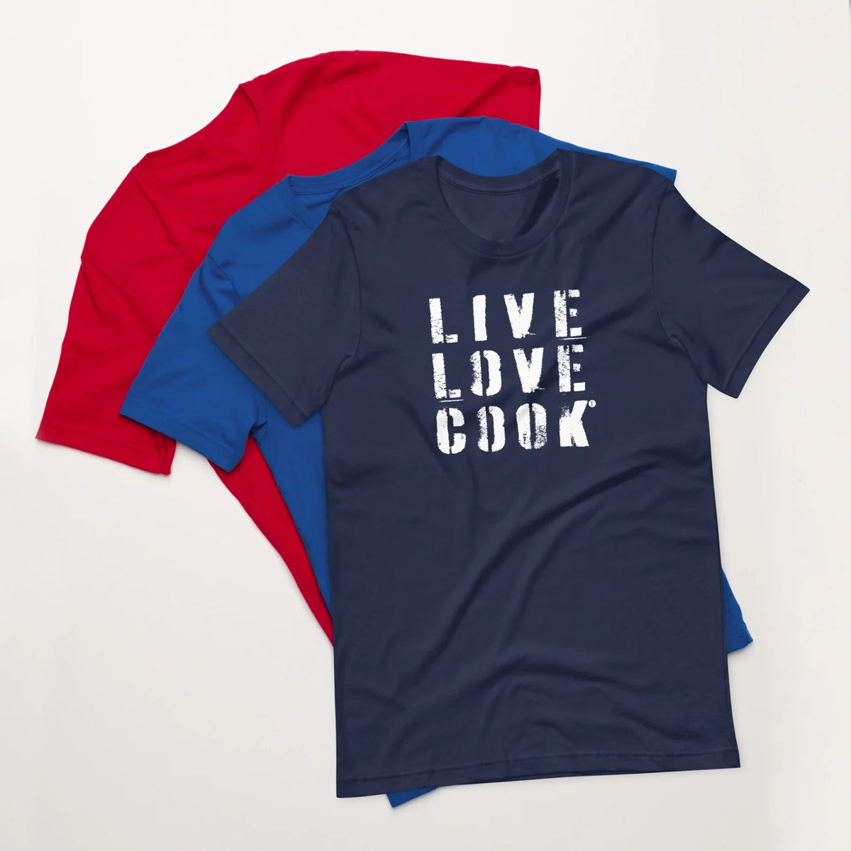 Drei Unisex T-Shirts von CREWILD in Rot, Blau und Dunkelblau mit Aufdruck LIVE LOVE COOK