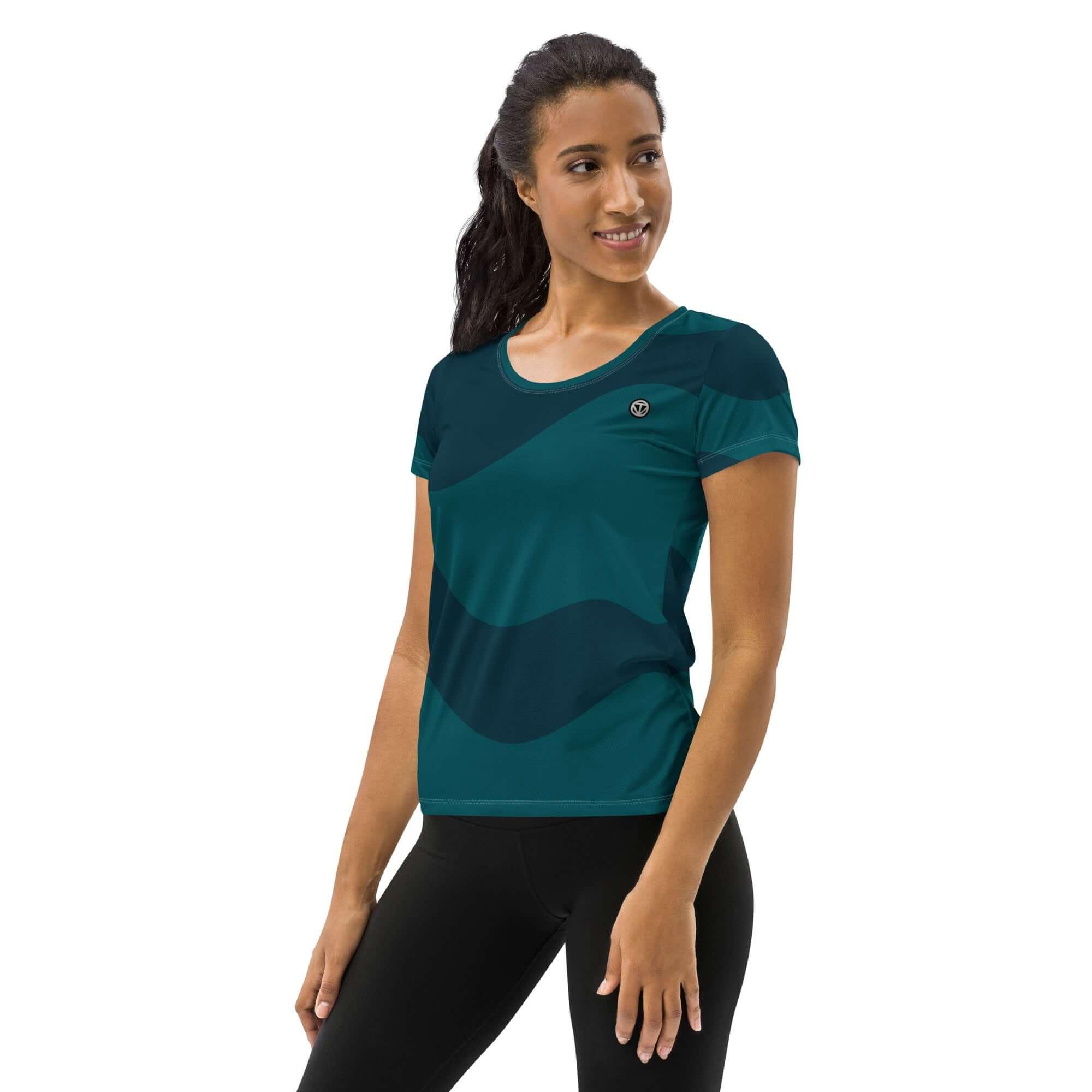 Frau trägt sportliches, dunkelgrünes Damen-Funktionsshirt mit Muster vor weißem Hintergrund
