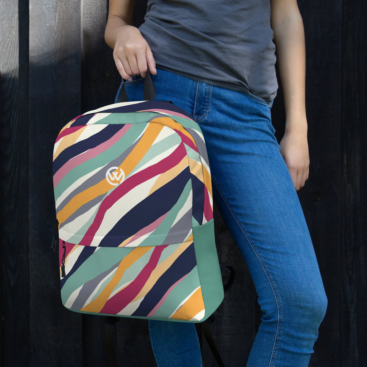 Person mit einem CREWILD Rucksack im bunten Wellenmuster-Design in verschiedenen Farben.