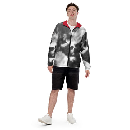 Mann in einer schwarz-weißen Tie-Dye-Jacke mit roter Kapuze und schwarzen Shorts