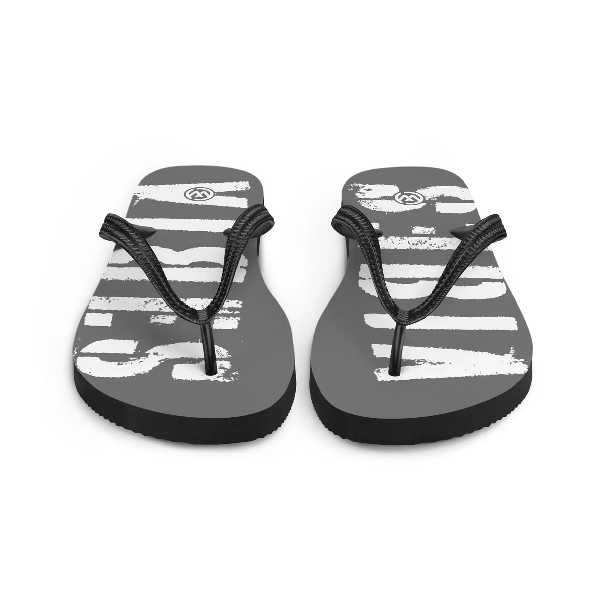 Grau-weiße CREWILD Flip-Flops mit auffälligem Grafikprint auf der Sohle.