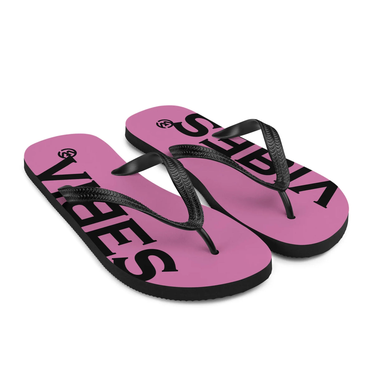 Pinke CREWILD Flip-Flops mit schwarzem VIBES Schriftzug und schwarzen Riemen.