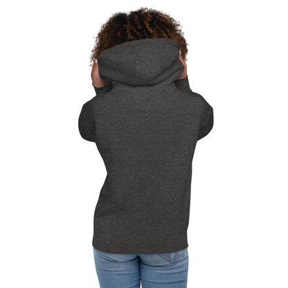 Rückansicht einer Person mit lockigem Haar in einem dunkelgrauen Hoodie und Jeans