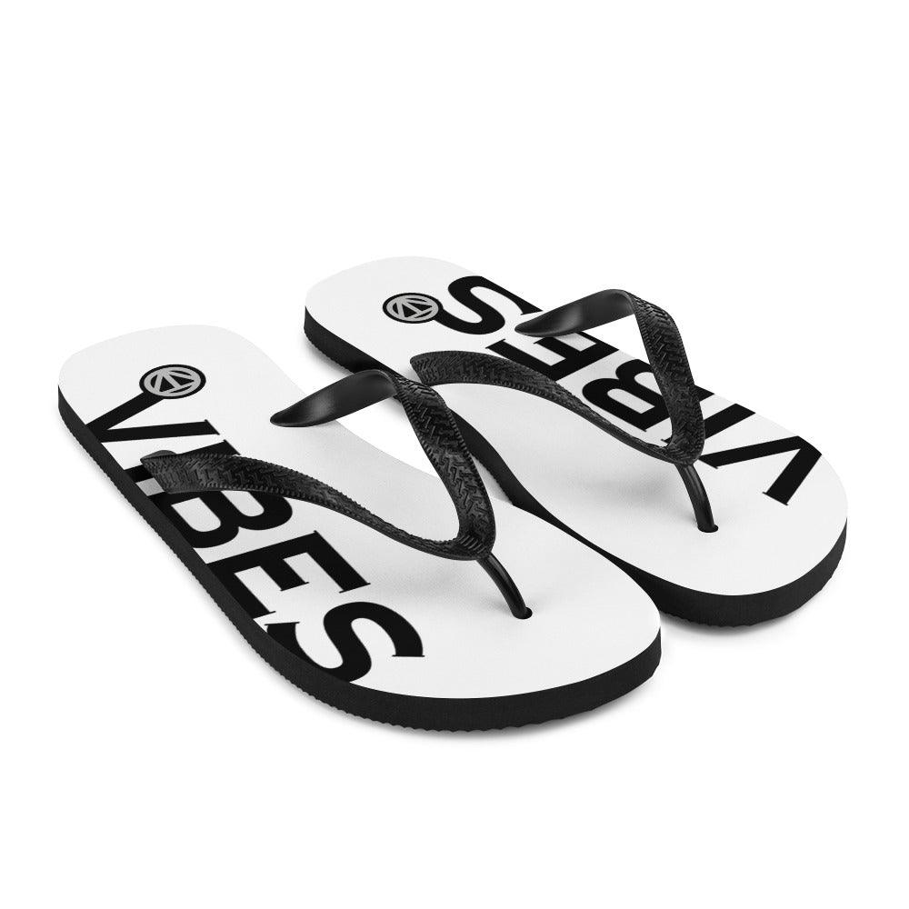 Weiße Flip Flops mit schwarzem Vibes-Aufdruck und schwarzen Riemen, Produktfoto